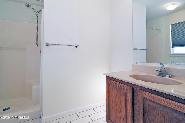 bathroom featuring vanity, tile patterned floors, and walk in shower