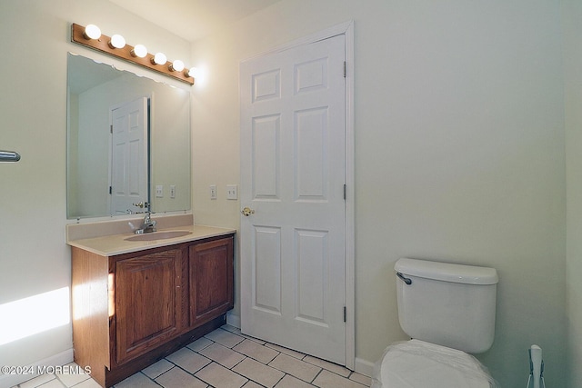 bathroom featuring tile patterned floors, vanity, and toilet