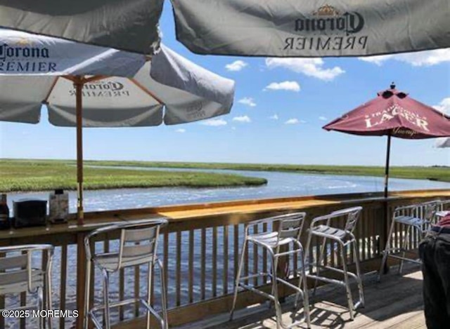 dock area featuring a water view and an outdoor bar