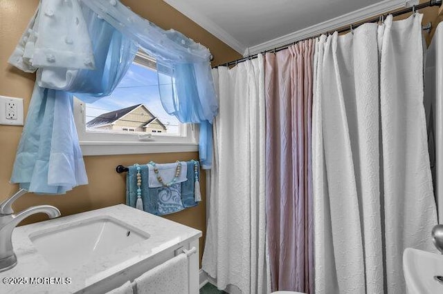 bathroom featuring crown molding and sink