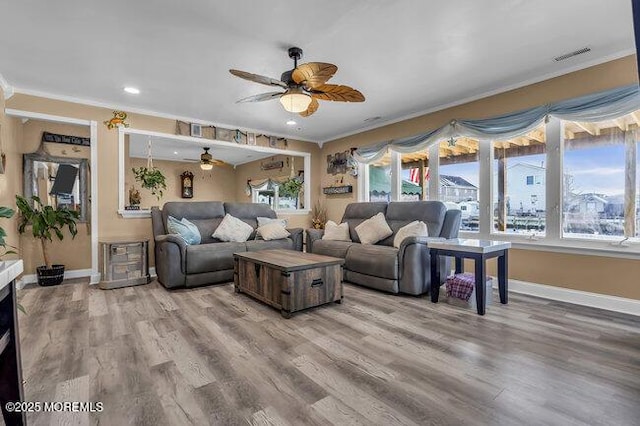 living room featuring crown molding, hardwood / wood-style floors, and ceiling fan