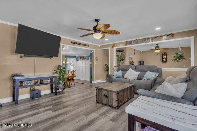 living room featuring crown molding, hardwood / wood-style flooring, and ceiling fan