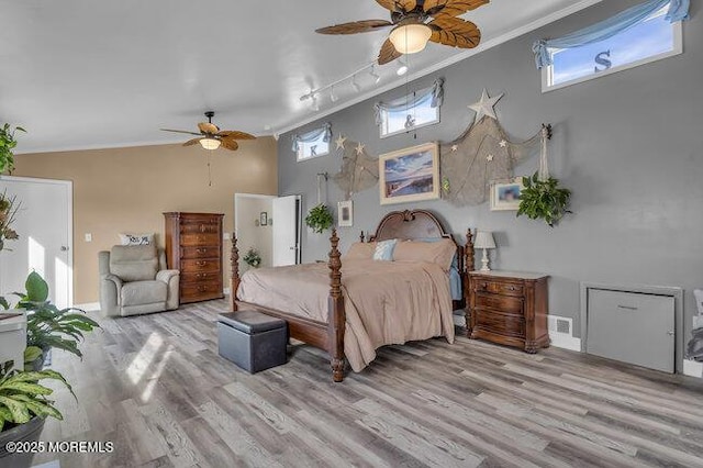 bedroom featuring ornamental molding, track lighting, ceiling fan, and light hardwood / wood-style floors