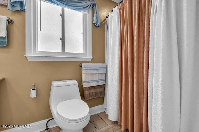 bathroom featuring toilet and tile patterned flooring