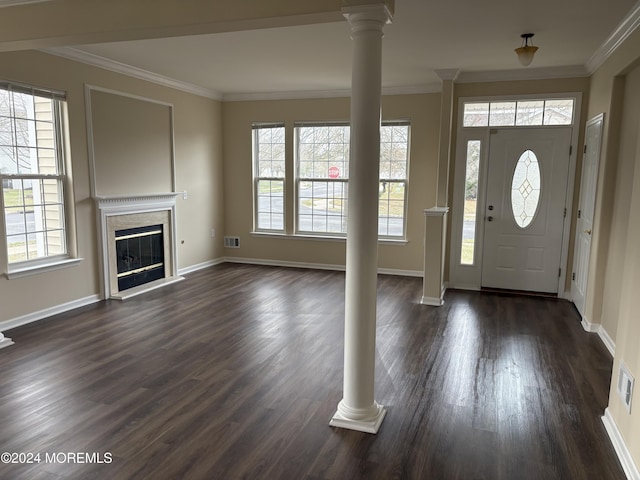 foyer with decorative columns, a wealth of natural light, crown molding, and dark hardwood / wood-style floors