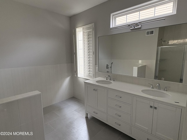 bathroom with tile patterned flooring, vanity, and an enclosed shower