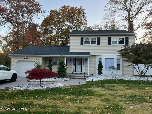 view of property with a front lawn and a garage