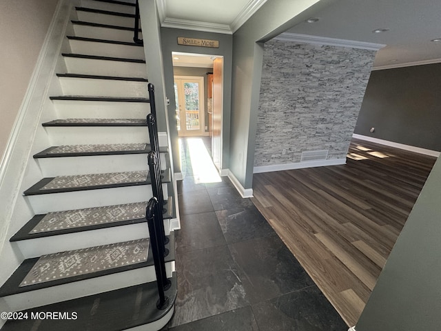 staircase with hardwood / wood-style flooring and ornamental molding