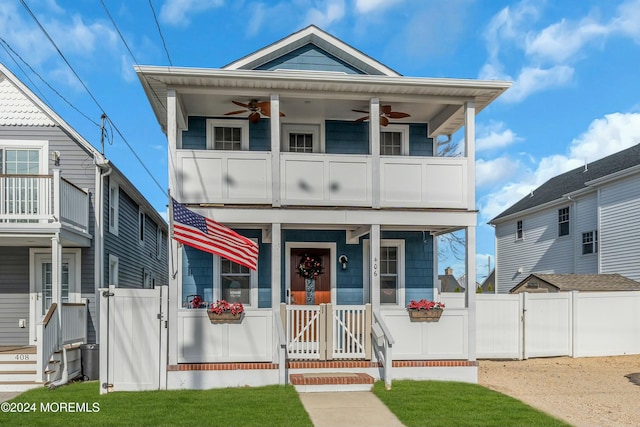 view of front facade featuring covered porch, ceiling fan, and a balcony