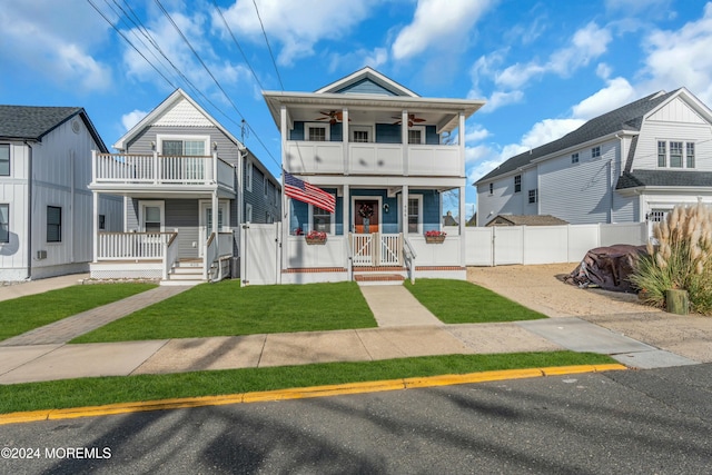 view of front of home featuring a balcony and a front yard