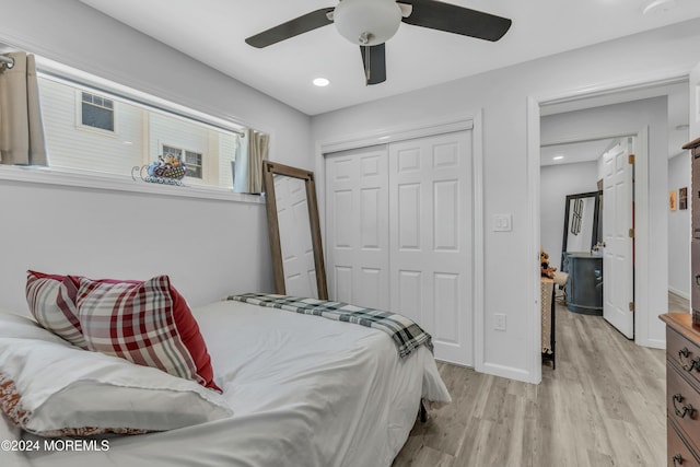 bedroom with a closet, ceiling fan, and light hardwood / wood-style flooring