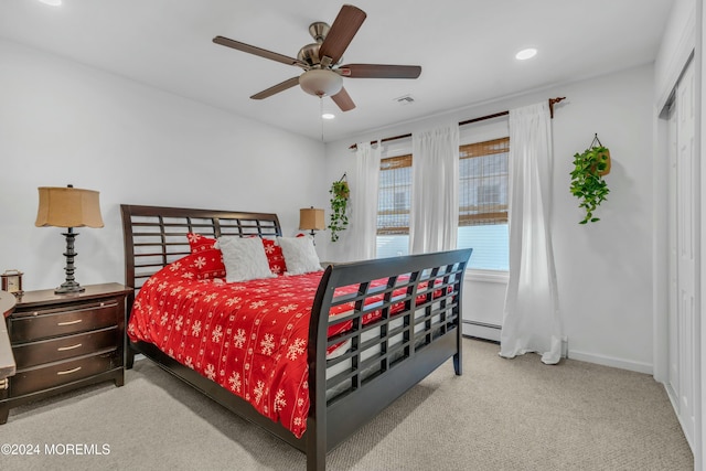 bedroom with ceiling fan, light colored carpet, and a baseboard radiator