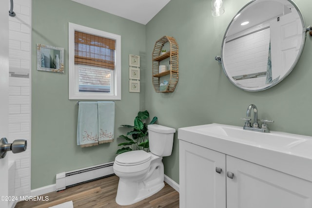 bathroom featuring hardwood / wood-style floors, vanity, toilet, and baseboard heating