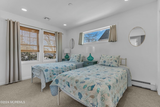 carpeted bedroom featuring a baseboard radiator