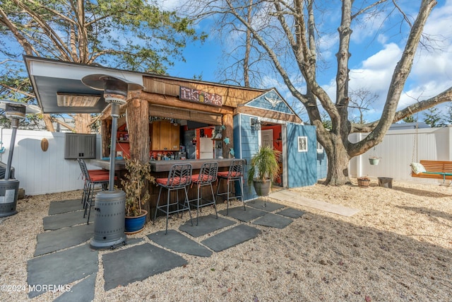 back of property with an outdoor bar