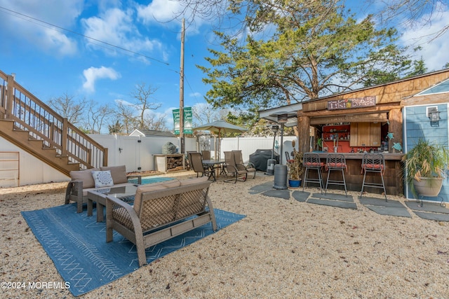 exterior space with a bar and an outdoor living space