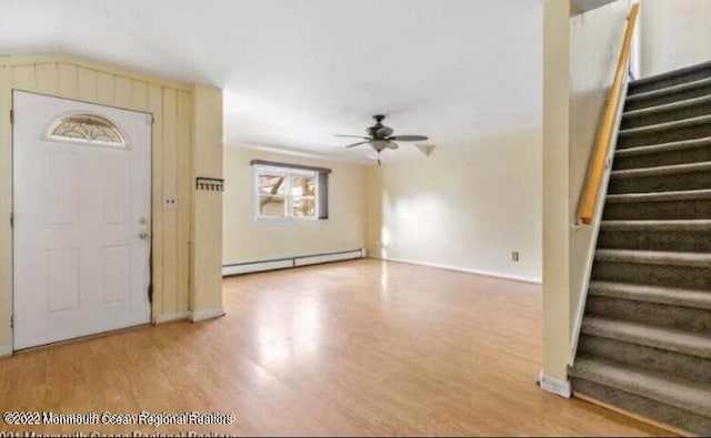 entrance foyer with hardwood / wood-style floors, ceiling fan, and baseboard heating