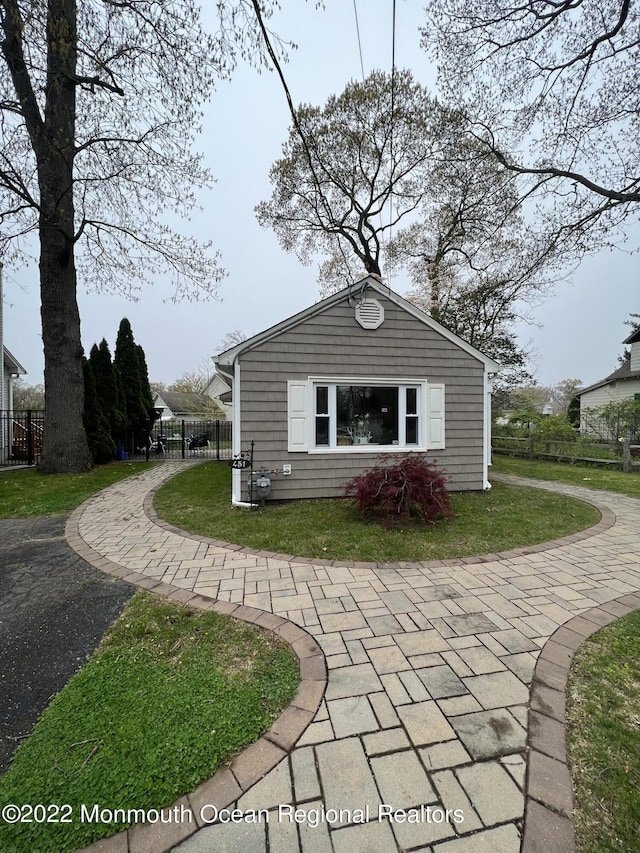 view of property exterior featuring a lawn