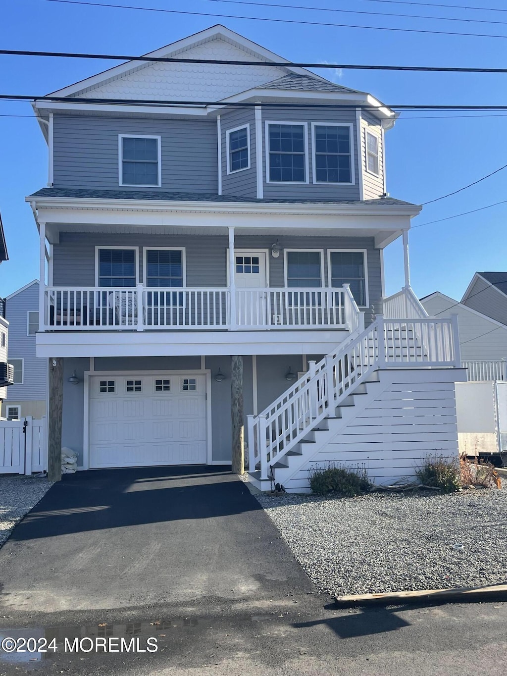 view of front of property with a porch and a garage