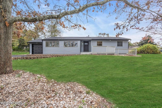 ranch-style house with a garage, a deck, and a front yard