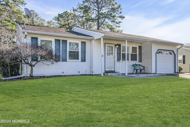 ranch-style home featuring a garage and a front lawn