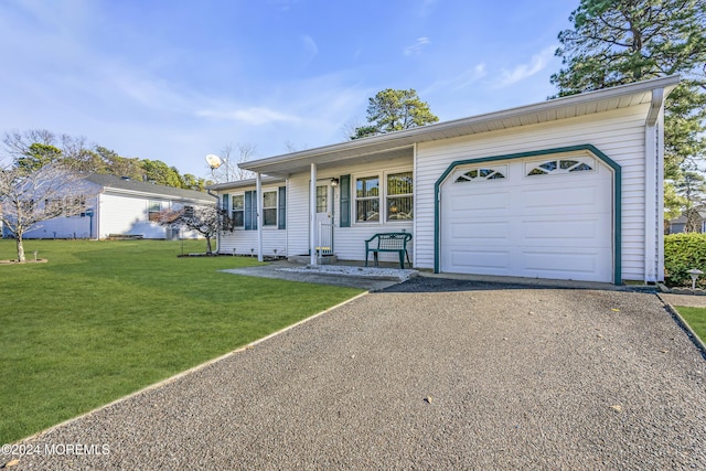 ranch-style house featuring a garage and a front lawn