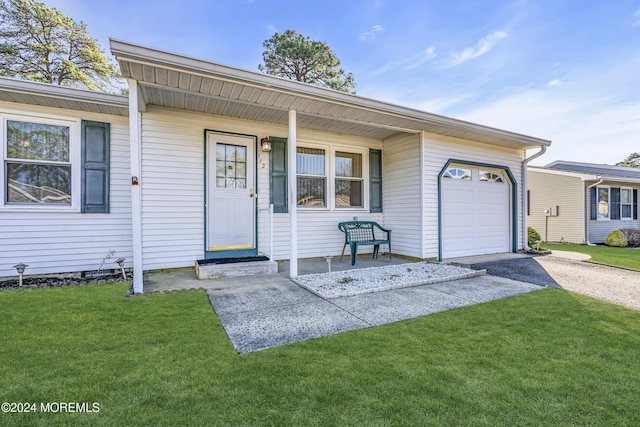 ranch-style house featuring a porch, a garage, and a front lawn