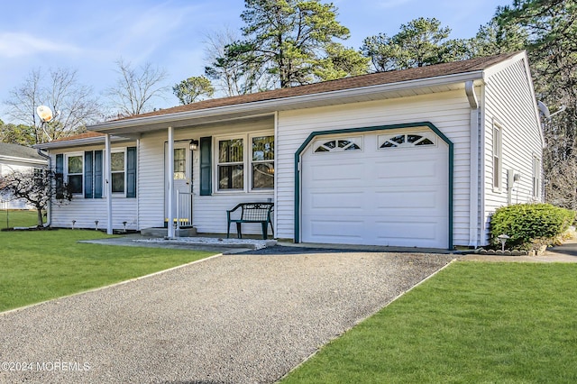 ranch-style house featuring a garage and a front lawn