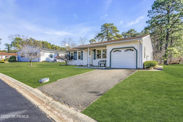 ranch-style home featuring a front lawn, covered porch, and a garage