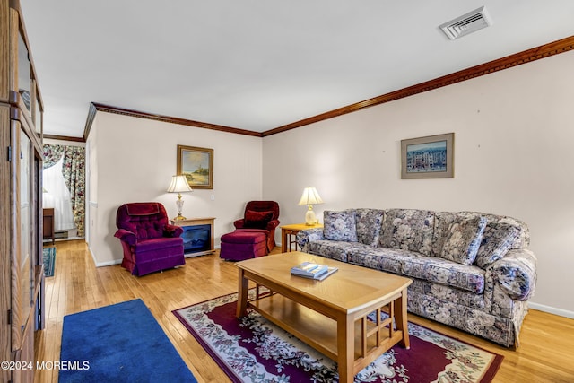 living room with hardwood / wood-style floors and ornamental molding