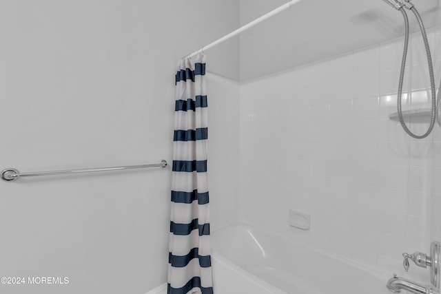 bathroom with shower / bath combo with shower curtain