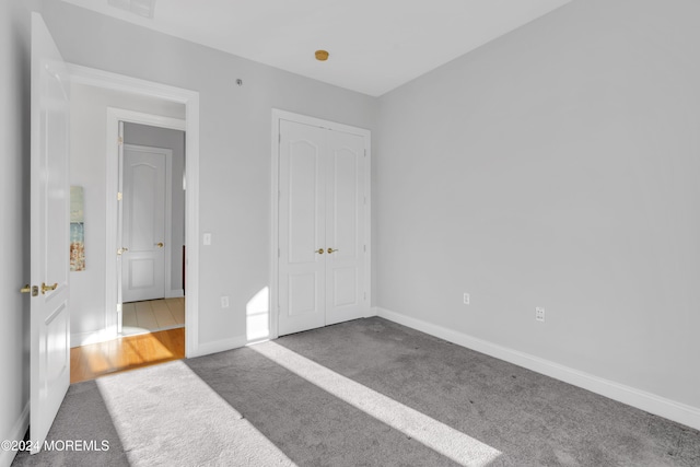 unfurnished bedroom featuring a closet and carpet