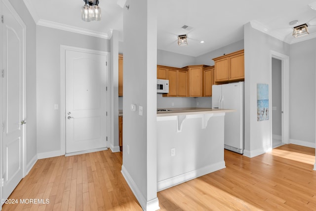 kitchen featuring light hardwood / wood-style floors, a kitchen bar, white appliances, and crown molding