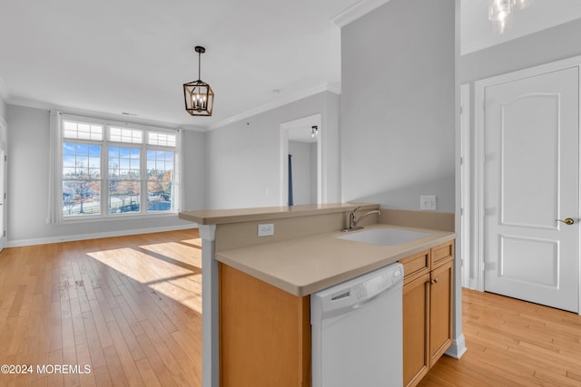 kitchen with dishwasher, light hardwood / wood-style flooring, hanging light fixtures, and sink