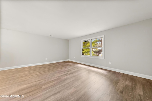 empty room with light hardwood / wood-style flooring