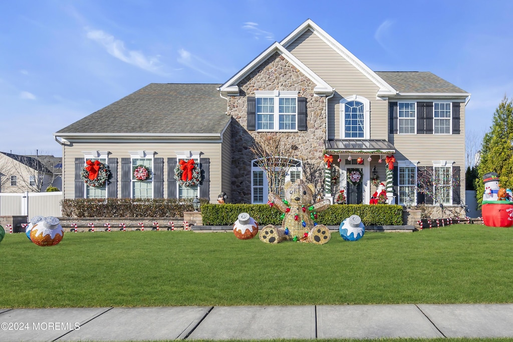 colonial inspired home with a front lawn