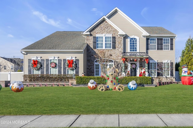 colonial inspired home with a front lawn