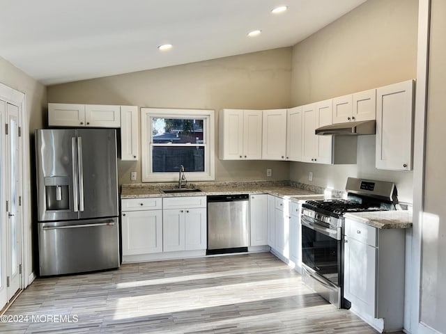 kitchen featuring white cabinetry, sink, lofted ceiling, and stainless steel appliances