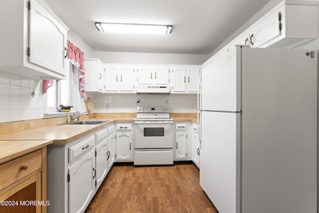 kitchen featuring white cabinetry, sink, white appliances, and hardwood / wood-style flooring