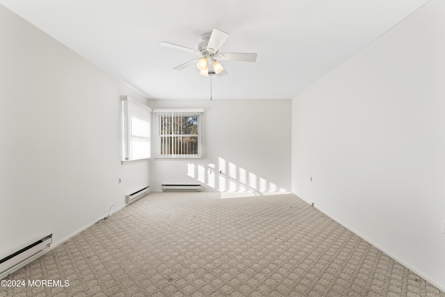 carpeted empty room featuring baseboard heating and ceiling fan