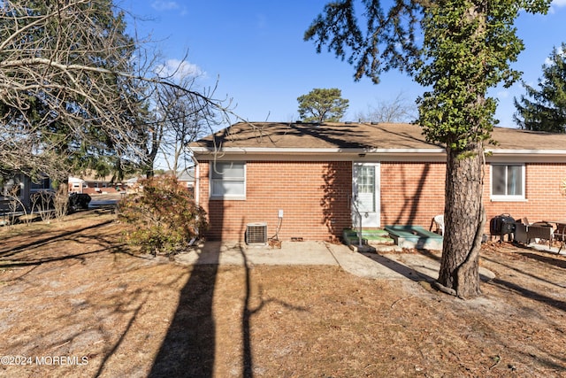 rear view of house featuring cooling unit