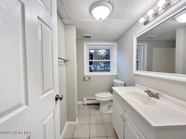 bathroom featuring tile patterned floors, vanity, toilet, and baseboard heating