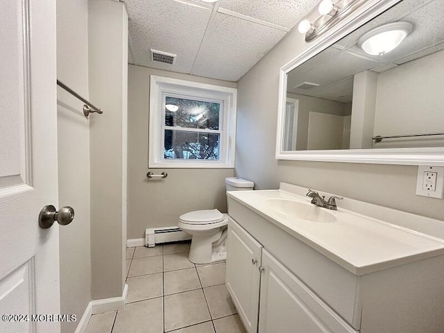 bathroom featuring toilet, vanity, tile patterned floors, and a baseboard heating unit