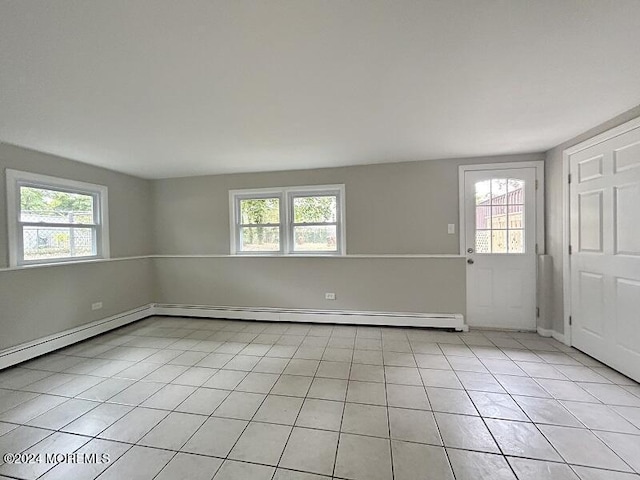 spare room with light tile patterned floors and baseboard heating