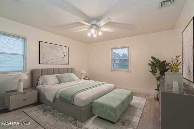 bedroom with light wood-type flooring and ceiling fan