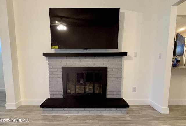 room details featuring wood-type flooring and a fireplace