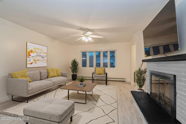 living room with light hardwood / wood-style floors, ceiling fan, and baseboard heating