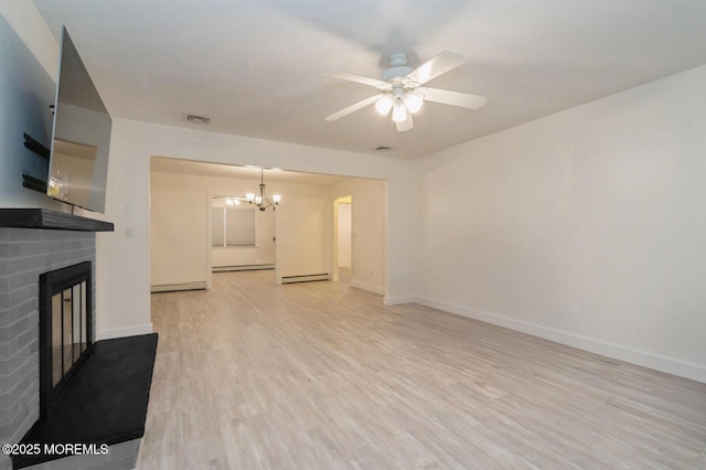 unfurnished living room with baseboard heating, a fireplace, ceiling fan with notable chandelier, and light hardwood / wood-style flooring