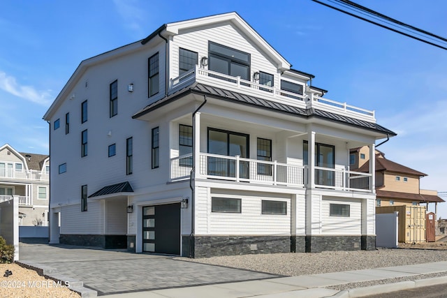 view of front of home featuring a balcony and a garage