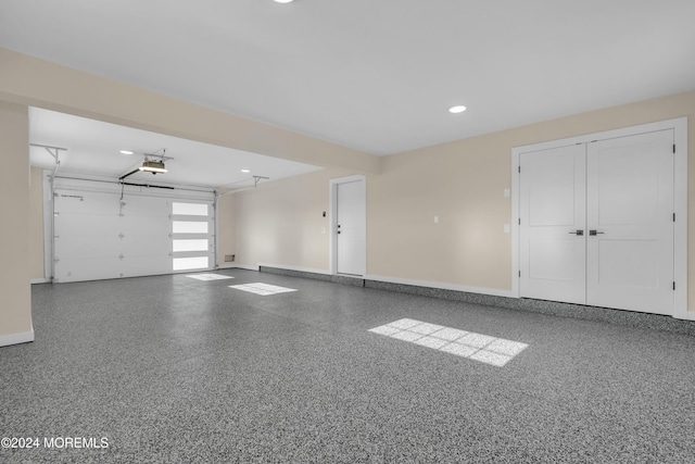 garage featuring recessed lighting, a garage door opener, and baseboards